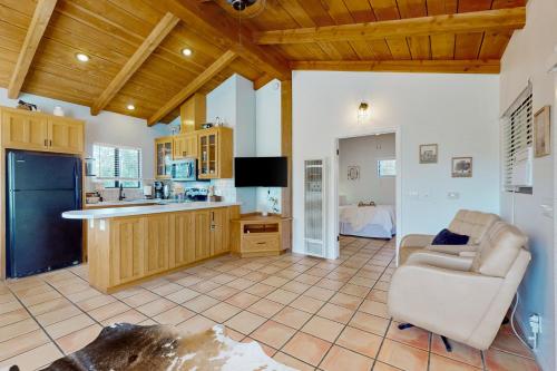 a kitchen with a couch and a chair in a room at Flyin' the Coop in Valley Center