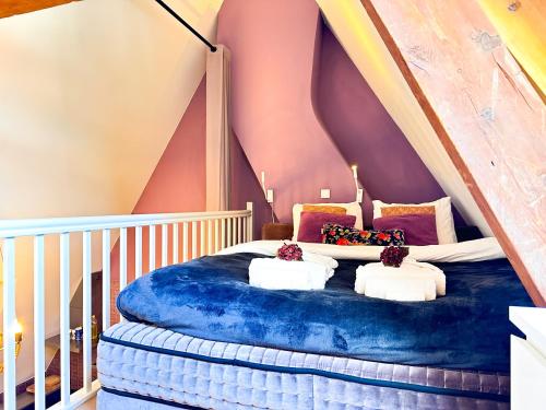 a bedroom with a blue bed in a attic at Gloria's loft op de Grote Markt in Breda
