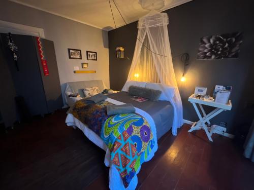 a bedroom with a bed with a canopy at Seaside Getaway @ Swallow House Suite #2 in Cape Town