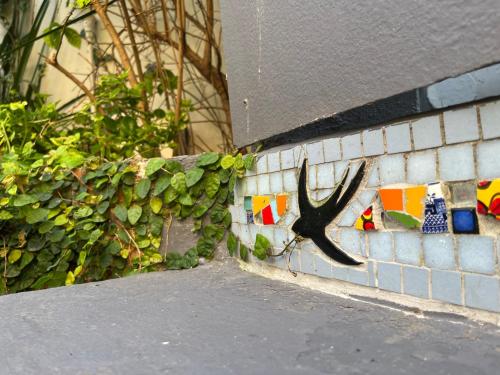 a wall with a black antler on it at Seaside Getaway @ Swallow House Suite #2 in Cape Town