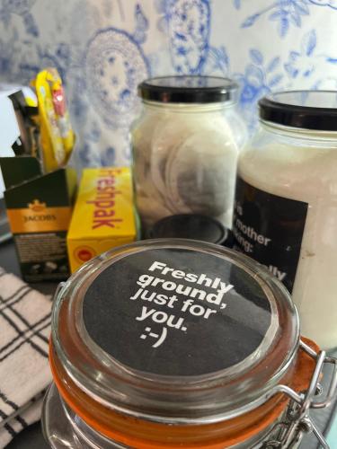 a jar of honey with a sign on it at Seaside Getaway @ Swallow House Suite #2 in Cape Town