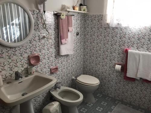 a bathroom with a sink toilet and a mirror at Da Nonna Nicoletta in Furore