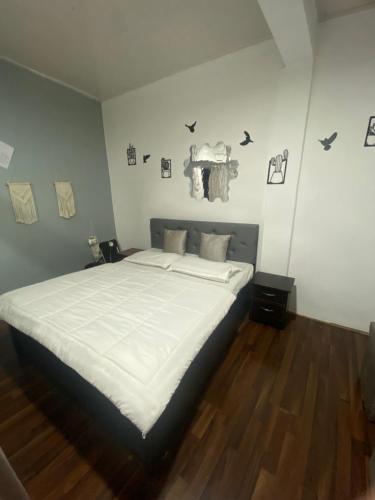 a bedroom with a large bed with white sheets at Noor Lyang in Gangtok