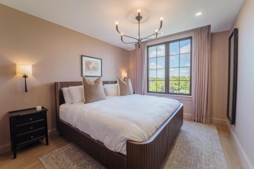 a bedroom with a large bed and a window at The Penrose Suites in Saint Marys