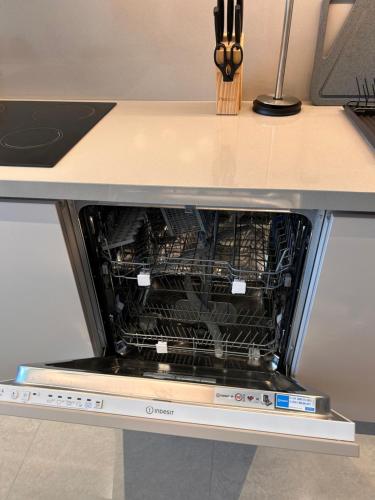 an oven with its door open in a kitchen at Address Residence Bahrain in Rayyā