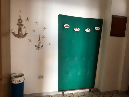 a green door with stickers on a wall at Da Nonna Nicoletta in Furore