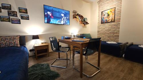 a living room with a table and chairs and a couch at Magiczne Mieszkanko in Piła