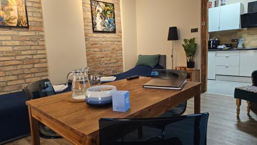 a room with a wooden table with a laptop on it at Magiczne Mieszkanko in Piła