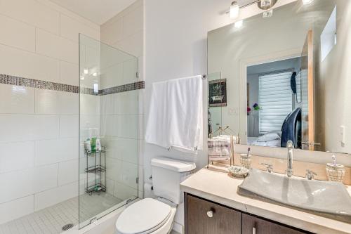 a bathroom with a toilet and a shower and a sink at Covered Patio and Grill Colorful McAllen Home in McAllen