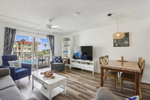 a living room with a table and a dining room at Spanish Trace 243 in St. Augustine