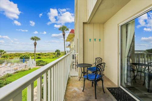 a balcony with a table and chairs and a view of the ocean at Spanish Trace 243 in St. Augustine