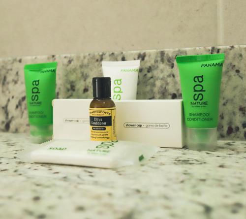 a bathroom counter with a bottle of sunscreen and other products at Sanctuary by Playa Caracol Residences in Punta Chame