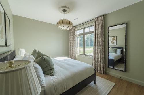a bedroom with a bed and a large mirror at The Penrose Suites in Saint Marys