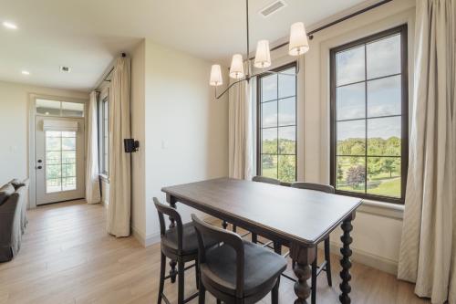 a dining room with a table and chairs and windows at The Penrose Suites in Saint Marys