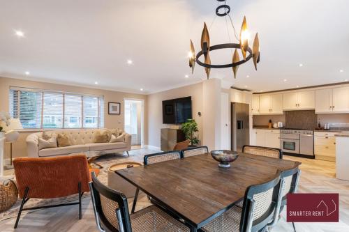 a dining room and living room with a table and chairs at Guildford - 4 Bedroom House - Private Parking in Guildford
