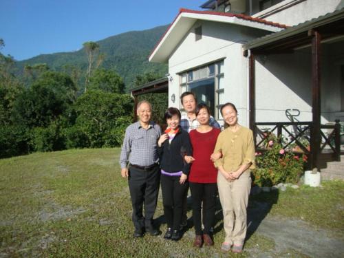 a group of people standing in front of a house at Taroko Sialin Coffee Farm Homestay in Xiulin