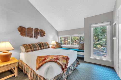 a bedroom with a bed and two windows at Carnelian Bay 2BR + Loft Near Beach & Trails in Carnelian Bay