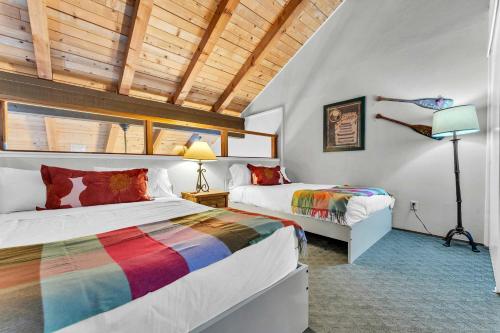 a bedroom with two beds with colorful blankets at Carnelian Bay 2BR + Loft Near Beach & Trails in Carnelian Bay