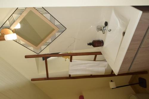 a bathroom with a mirror and a sink at Sonho Paixão in São Vicente