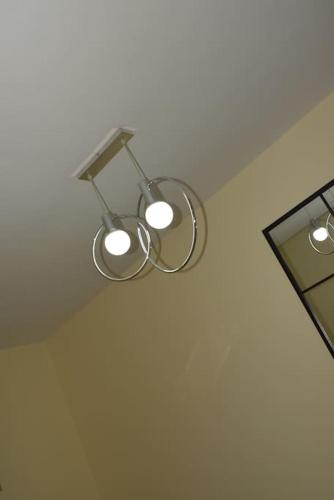 a pair of lights hanging from a ceiling at Sonho Paixão in São Vicente