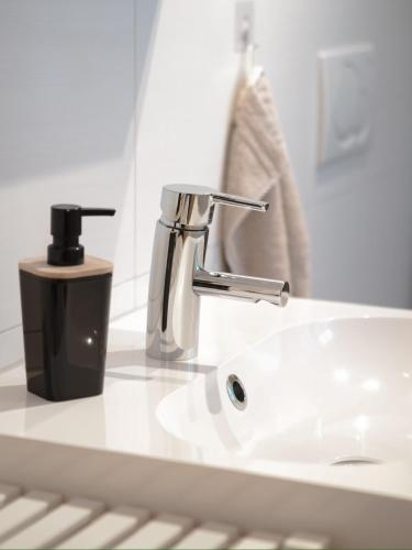 a bathroom sink with a faucet on a counter at Ferienwohnung in Ruppichteroth Winterscheid im EG mit Garten und Klima in Ruppichteroth