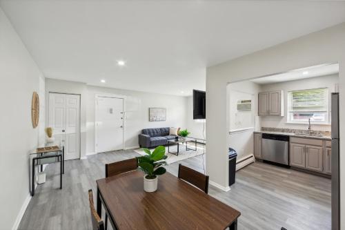 a living room with a table and a kitchen at Pine Brook 1019 I Modern 15br Apartment ! Pool in Newark
