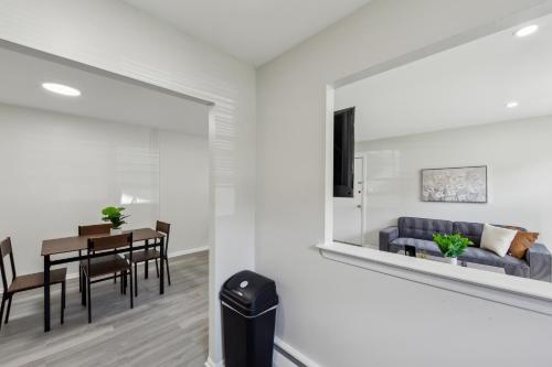 a living room with a table and a couch at Pine Brook 1019 I Modern 15br Apartment ! Pool in Newark