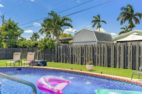 a pool with two inflatable boats in a yard at Amazing Home w Heated Pool 8 mins to the Beach in Lighthouse Point