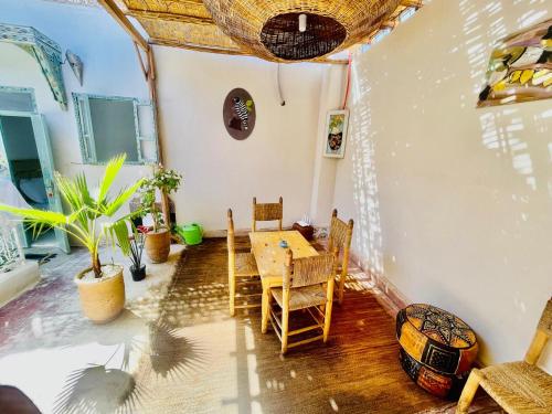 a dining room with a table and chairs in a room at Riad Dar Lokman in Marrakech