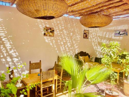 a dining room with a table and some plants at Riad Dar Lokman in Marrakech