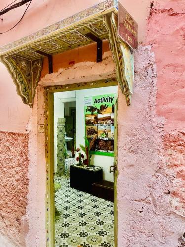 an entrance to a store with a pink building at Riad Dar Lokman in Marrakech