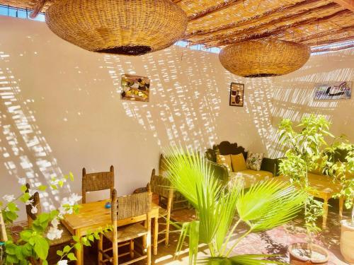 a room with a table and chairs and some plants at Riad Dar Lokman in Marrakech