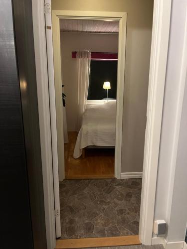 a view of a bedroom with a bed and a mirror at Villa lilla lavendel in Kungsängen