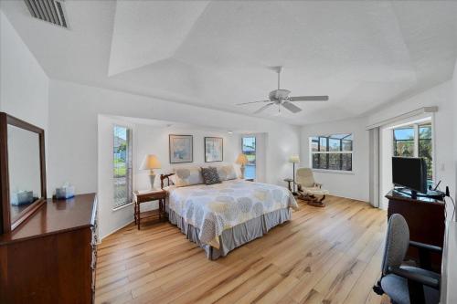 a bedroom with a bed and a ceiling fan at Southern Breeze in Rotunda-West