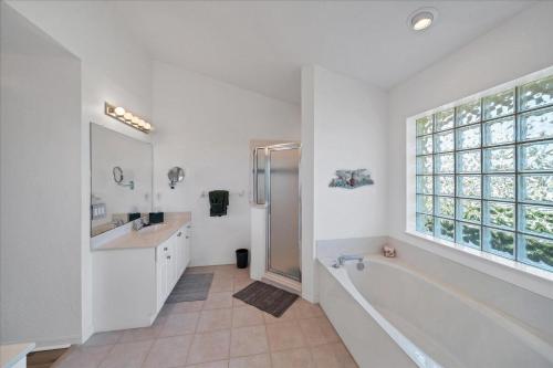 a bathroom with a tub and a sink and a shower at Southern Breeze in Rotunda-West
