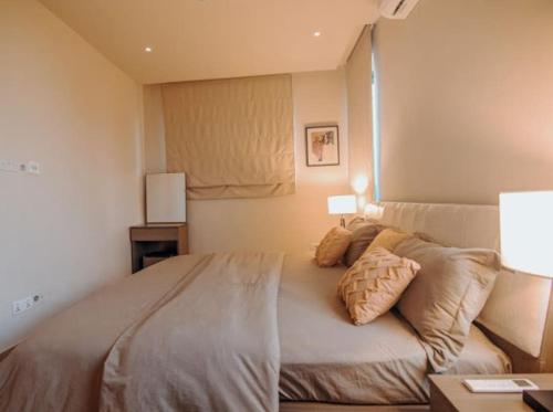 a bedroom with a large bed with two pillows at Big Chill Stays Legon in North Legon