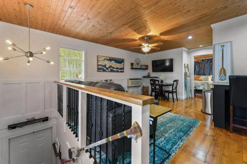 a living room and dining room with a ceiling fan at Bare Feet Bungalow -Close to beach & dog friendly in Gulfport