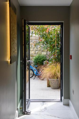 an open door to a garden with a motorcycle outside at Rowing club house in Carrick on Shannon
