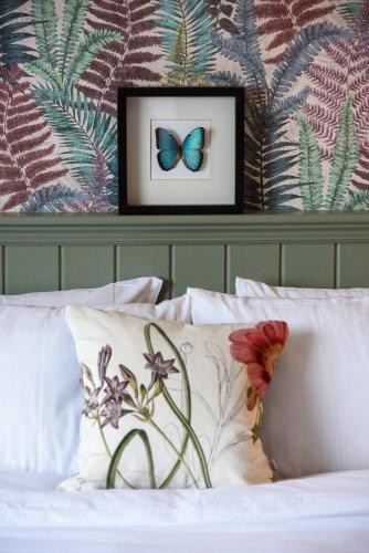 a bedroom with a bed with a butterfly on the wall at Rowing club house in Carrick on Shannon