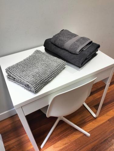 a white desk with two towels on top of it at Pensión Guggenheim Riverview HBI01297 in Bilbao