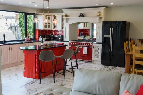 a kitchen with a red island in the middle at Rowing club house in Carrick on Shannon