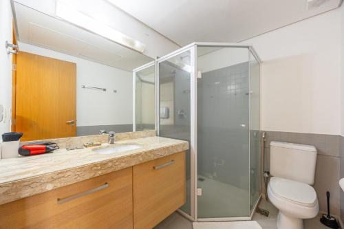 a bathroom with a toilet and a sink and a shower at STD - Anora Spaces - Stadium Alphaville in Barueri