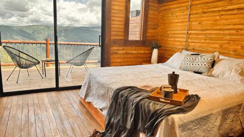 a bedroom with a bed and a balcony with a view at Casa Tikkun in Medellín