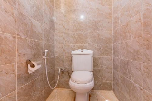 a bathroom with a toilet and a toilet paper dispenser at Wadi Rum night soul Camp in Wadi Rum