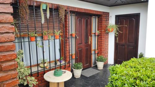 a house with a fence with potted plants on it at Chalet residencial Maroli in Mar del Plata