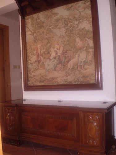 a painting on a wall above a wooden cabinet at Villa Jelena in Zadar