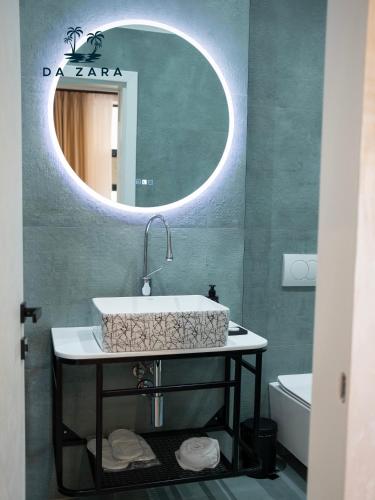 a bathroom with a sink and a mirror at Da Zara Hotel in Lalzit Bay