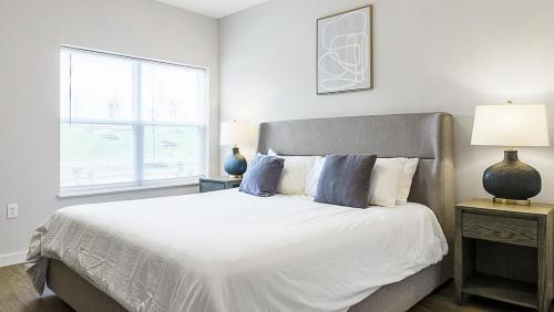 a white bedroom with a large bed and a window at Landing at The Landing - 2 Bedrooms in Clermont in Indianapolis