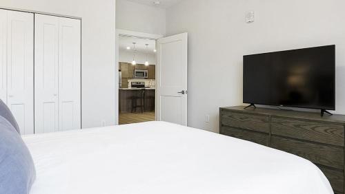 a bedroom with a bed and a flat screen tv at Landing at The Landing - 2 Bedrooms in Clermont in Indianapolis
