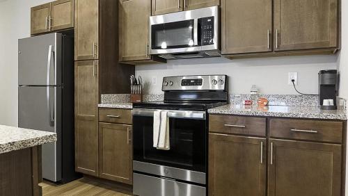 a kitchen with a stove and a microwave at Landing at The Landing - 2 Bedrooms in Clermont in Indianapolis